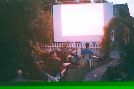 (outdoor movie starting)